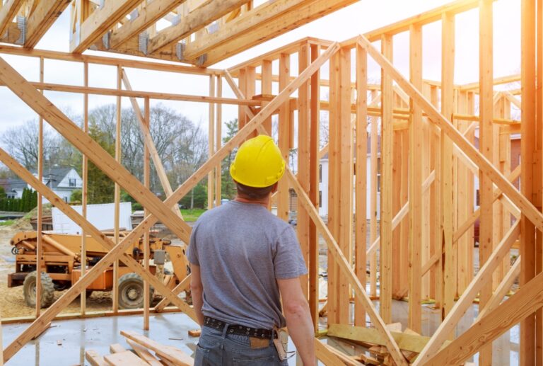 Man in a hardhat building a new home